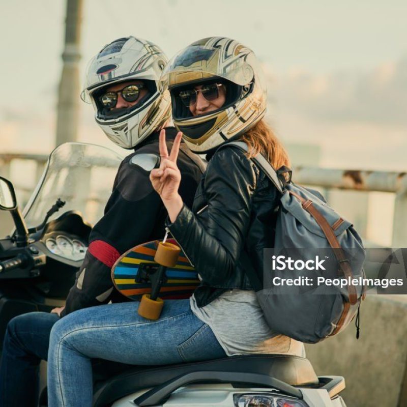Cropped shot of a young attractive couple riding a scooter around town